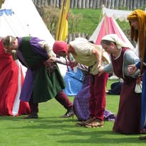 dancers of the Medieval combat society take a bow after their performance